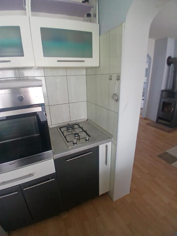 a kitchen with a stove and a stove top oven at Luce in Tomislavgrad
