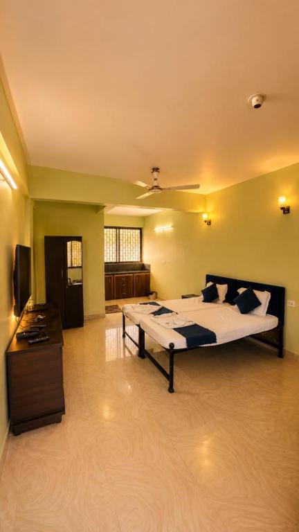 a bedroom with a large bed in a room at Colors Fly Hotel in Colva