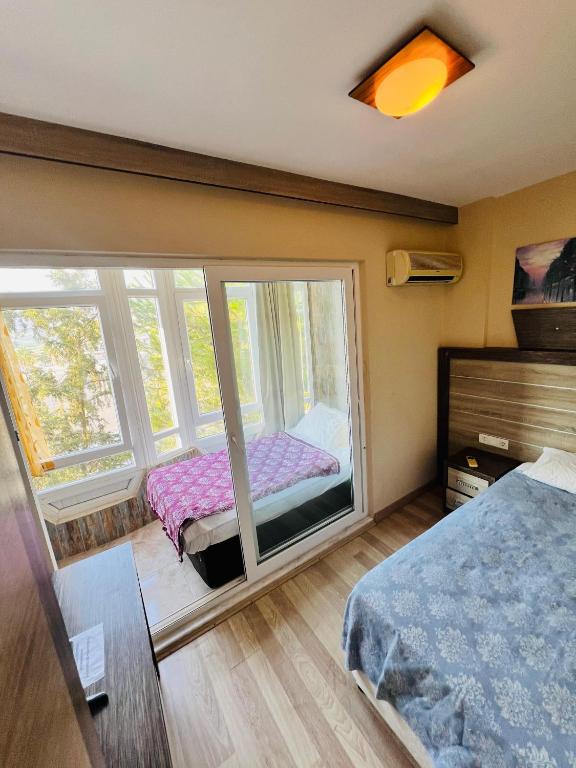 a bedroom with a bed and a large window at Selinus Beach Club Hotel in Gazipasa