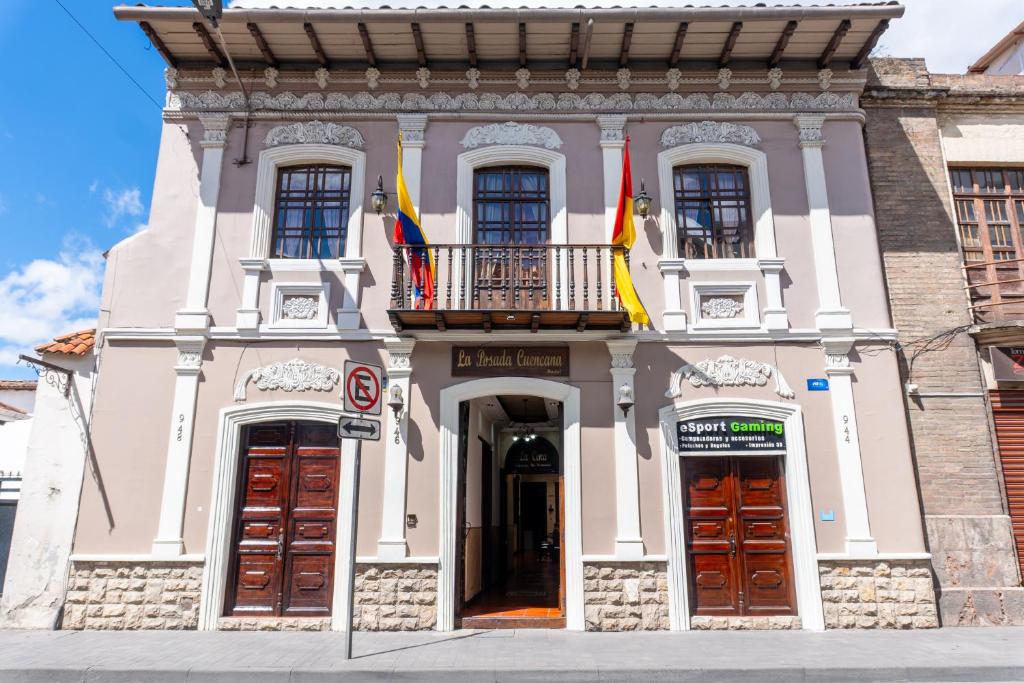 a building with two flags on top of it at La POSADA CUENCANA EN CUENCA in Cuenca