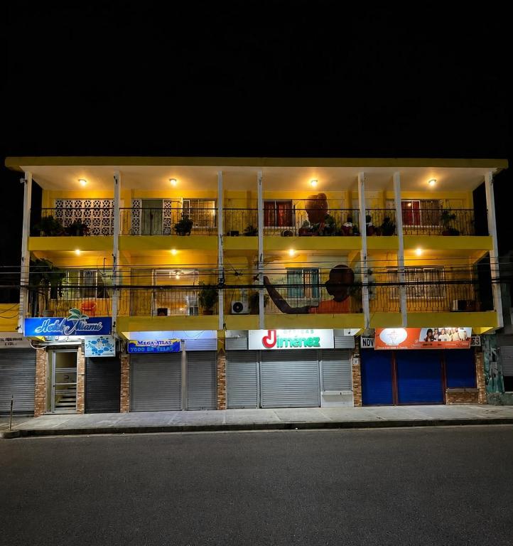 a building with balconies on the side of it at night at Hotel Miami CR in Puerto Limón