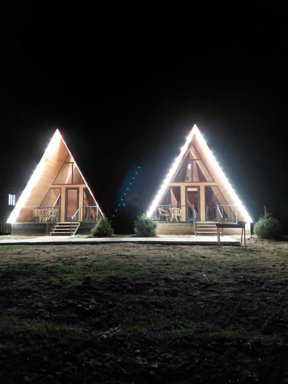 a large building with lights on it at night at Kolsai Star House in Saty