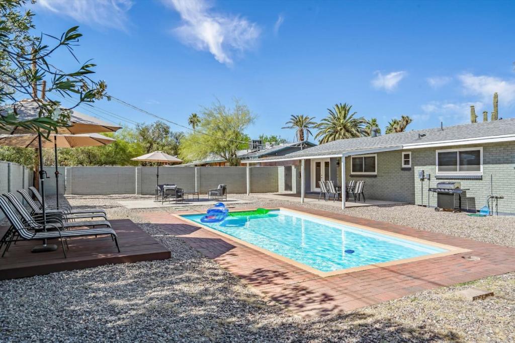 a swimming pool in front of a house at Tucson Oasis by Rather Be Properties in Tucson