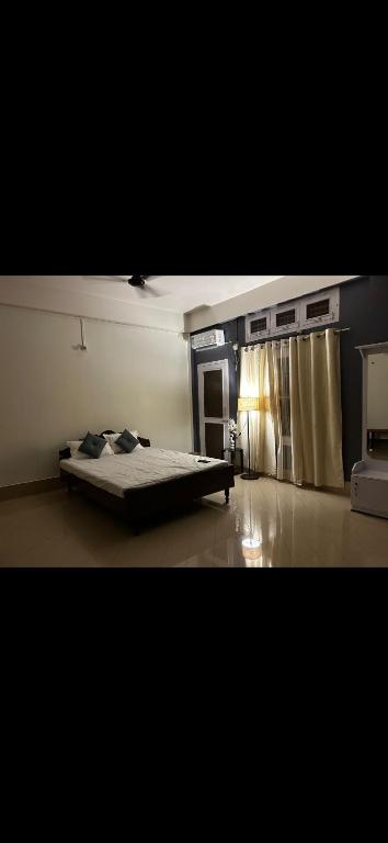 a bedroom with a bed in the corner of a room at Pipits cozynest in Tezpur