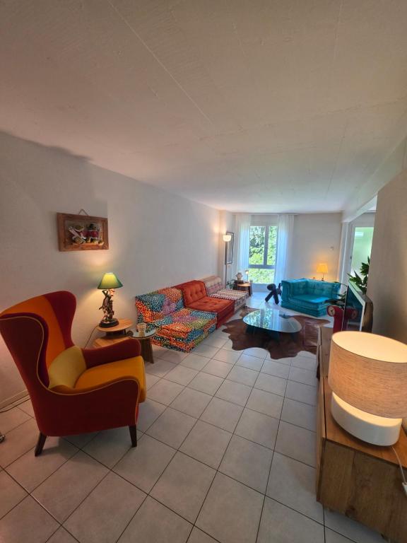 a living room with a couch and a table at Appartement 188m2 in Crans-Montana