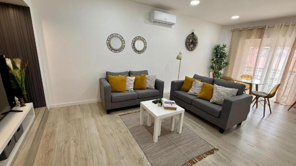 a living room with two couches and a table at Bela House, By Home Match in Setúbal