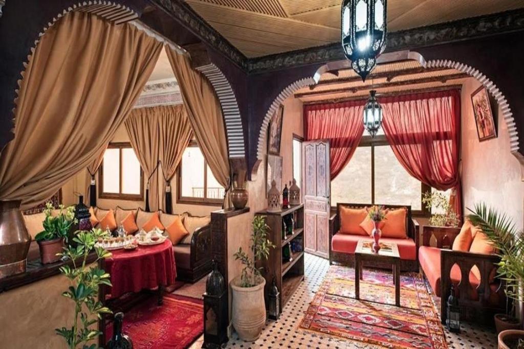 a living room with a couch and a table at Atlas Prestige in Imlil