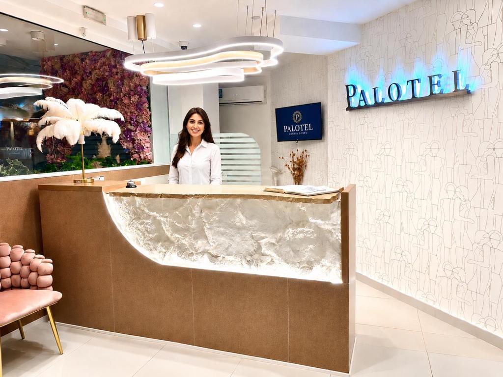 a woman standing at the counter of a salon at Palotel Gouvia Hotel in Gouvia