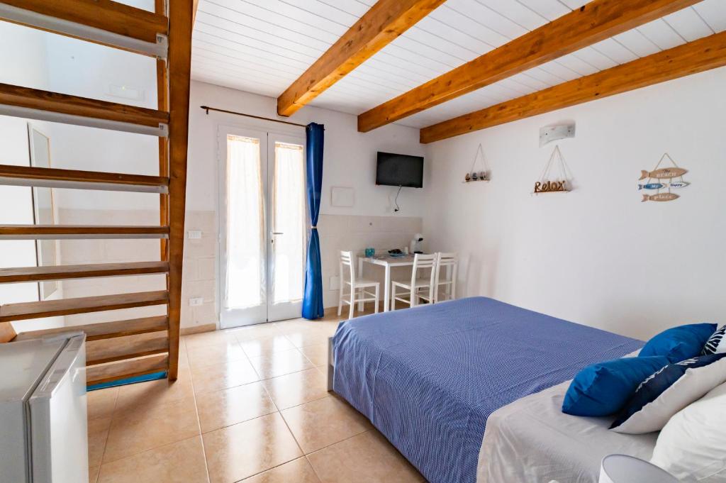 a bedroom with a bed and a table in a room at Poseidonia nel Borgo in Pulsano