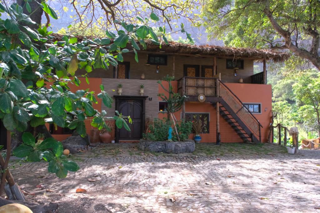 a house with a staircase in front of it at Eco Lodge ZEN GARDEN in Paul