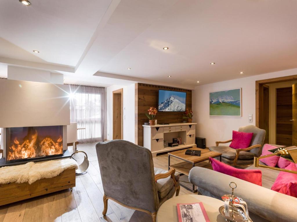 a living room with a fireplace and a couch at Premium Mountain View Suite in Kirchberg in Tirol