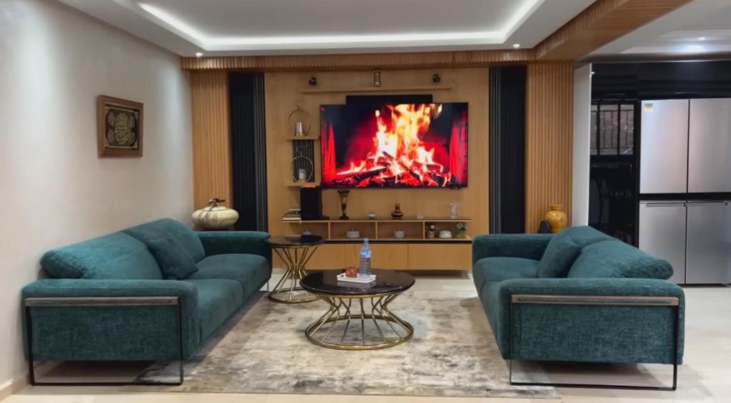 a living room with two blue couches and a fireplace at YourHome in Casablanca