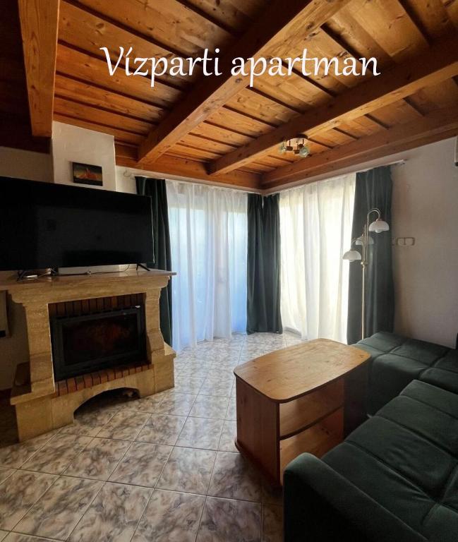 a living room with a couch and a fireplace at Sziget Apartman Fonyód in Fonyód
