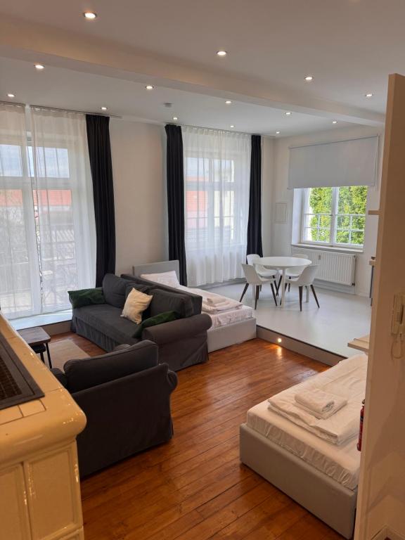 a living room with a couch and a table at Bavaria Home Modern Living in Geisenfeld