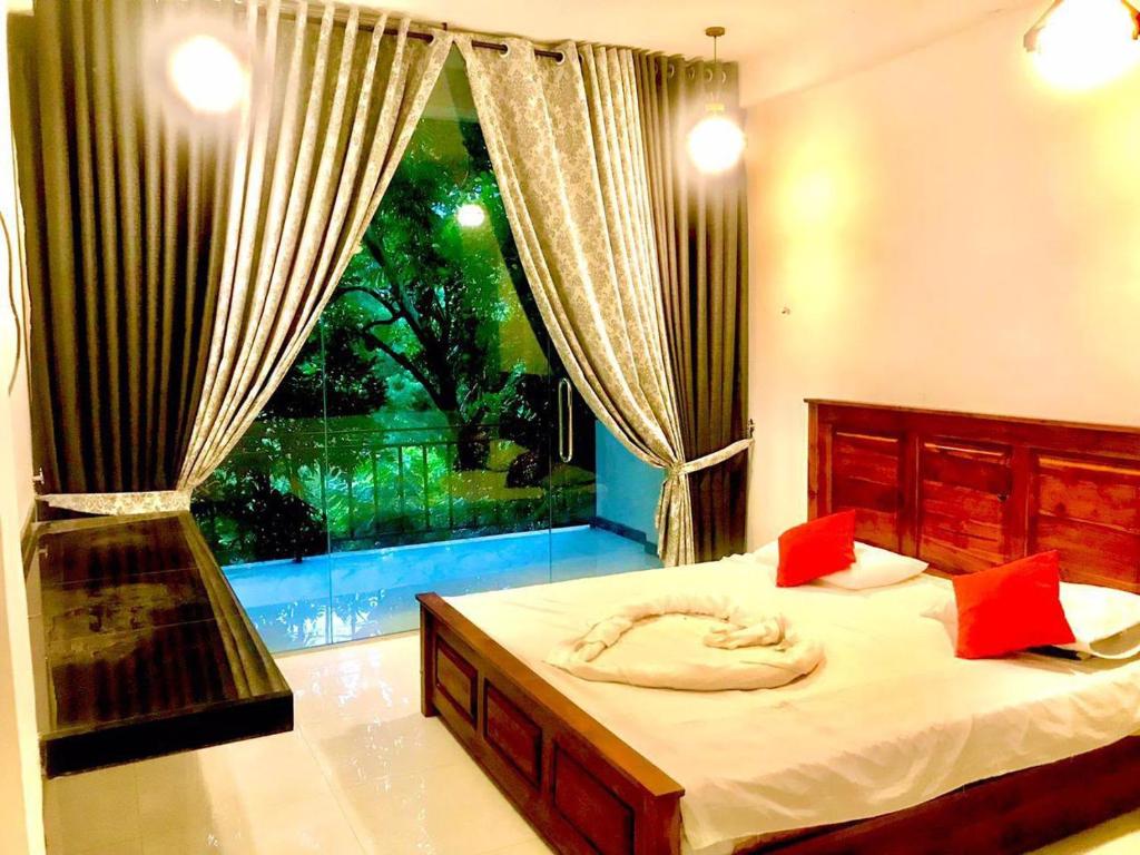 a bedroom with a bed and a large window at Verona Heights Ella in Ella