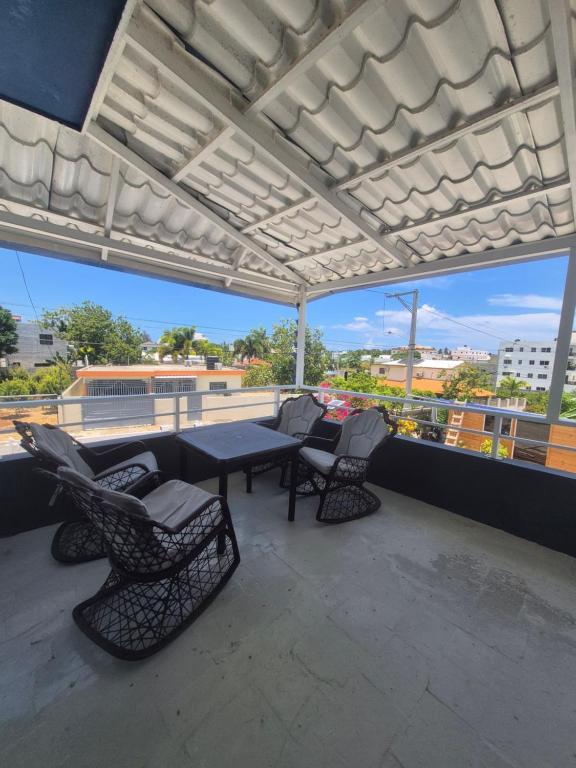 a patio with a table and chairs on a roof at OMY Apartments Nagua 2A in Nagua