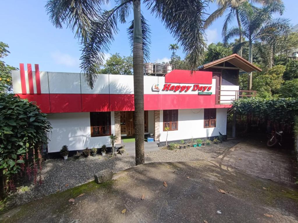 a building with a coca cola sign on it at Happy Days by 3R Munnar in Munnar