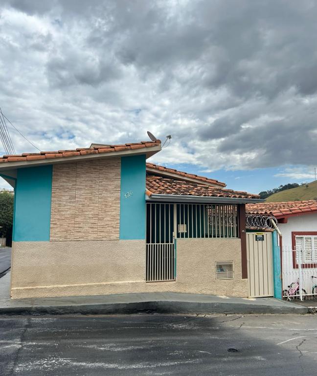 a building with a gate on the side of a street at Casa da Conceição in Capitólio