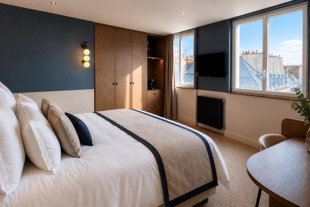 a bedroom with a large bed and a television at 336 Saint-Honore By Chapitre Collection in Paris