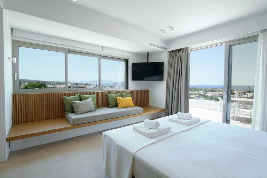 a hotel room with a bed and a couch and windows at Homey - a living space in Daratso