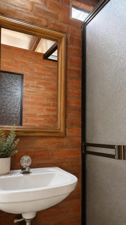 a bathroom with a sink and a mirror at Apartaestudio amoblado in Jamundí