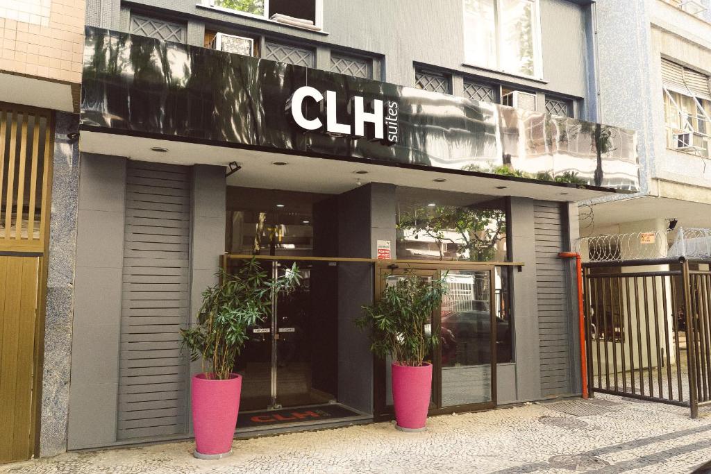 a store front with two potted plants in front of it at CLH Suites Domingos Ferreira in Rio de Janeiro