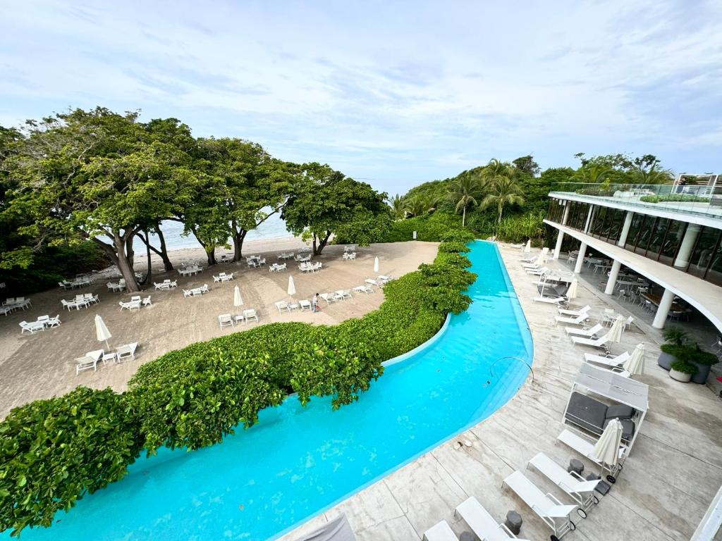 an aerial view of a resort with a pool and a beach at Departamento Playa Dorada Punta Mita, Beach Front in Punta Mita