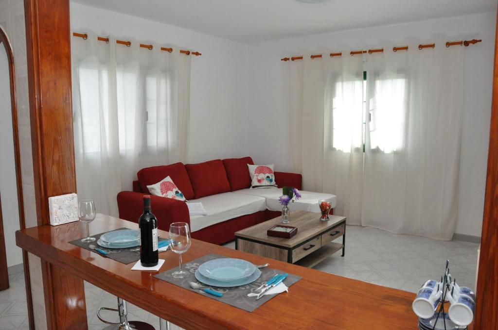 a living room with a couch and a table at La Casita de Mari Carmen in Mala