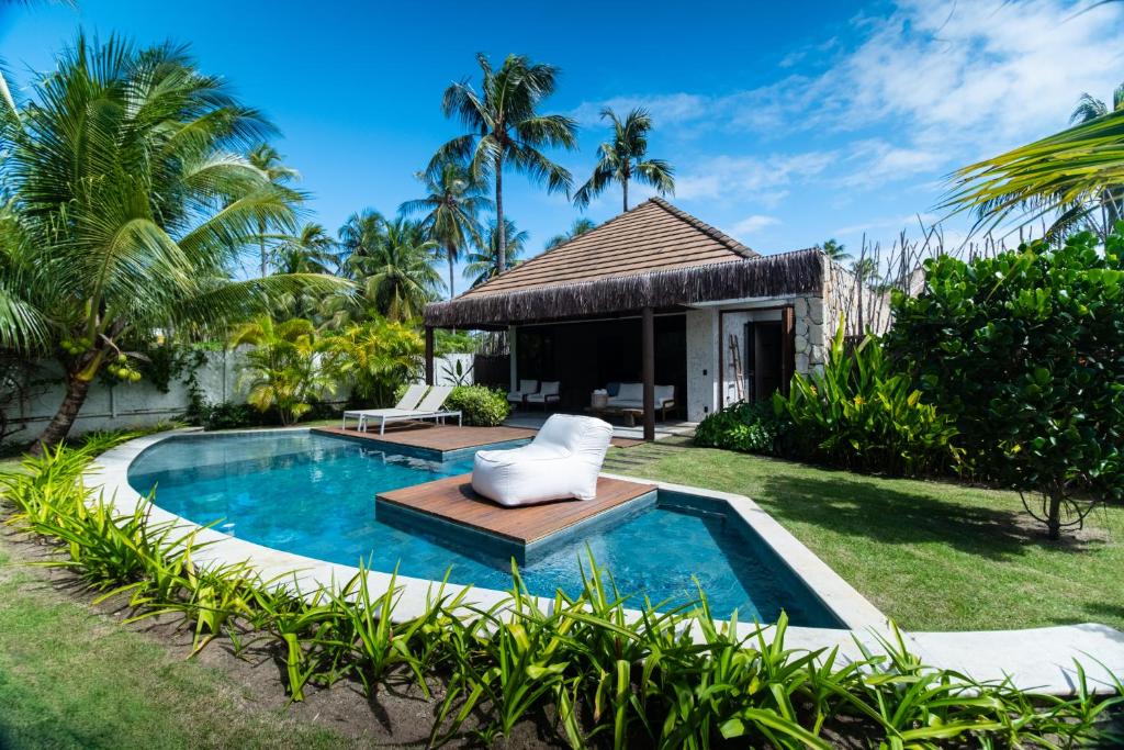 a villa with a swimming pool and a resort at NANNAI Milagres in São Miguel dos Milagres