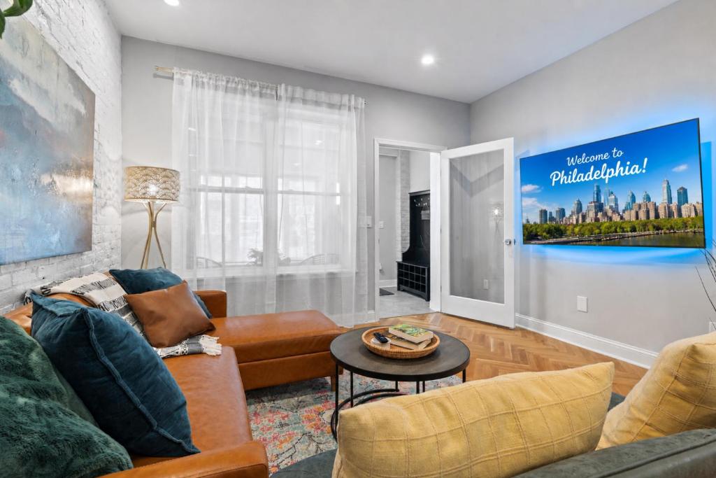 a living room with a couch and a table at Spacious 3BR Near Art Museum Patio Gameroom in Philadelphia
