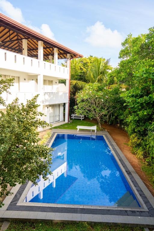 an aerial view of a swimming pool in front of a building at Jippie The Villa in Hikkaduwa