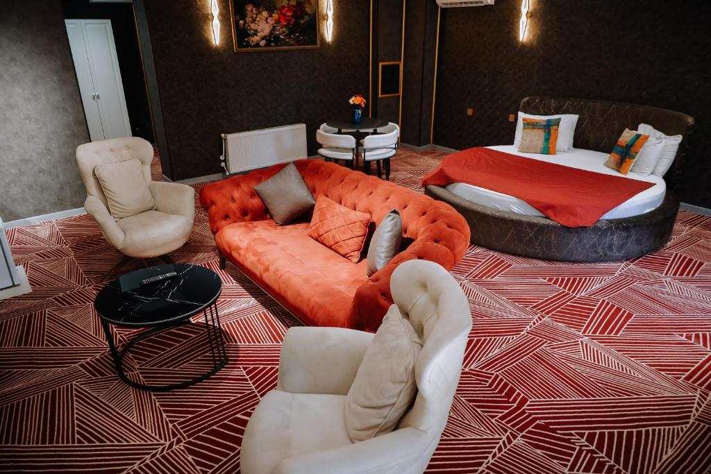 a living room with a couch and a bed at Avenue Nizami hotel in Baku