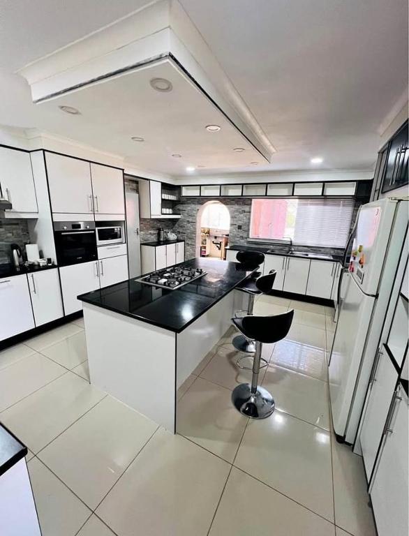 a kitchen with a black counter top and a stove at BillGates BNB in Harare