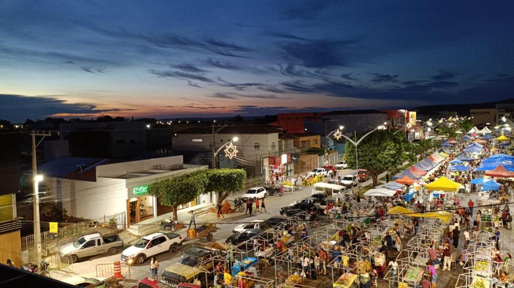a crowd of people at an outdoor market at night at Pousada Panorama Palace in Santa Maria da Vitória