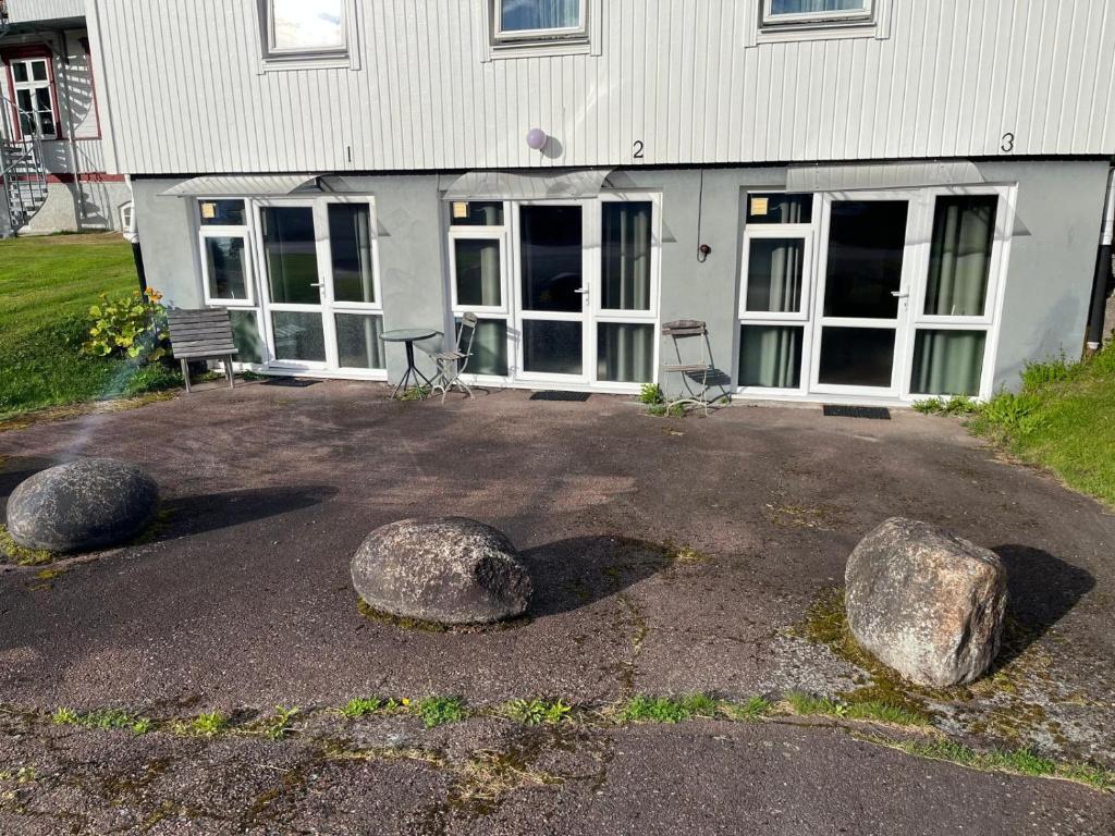 a house with two large rocks in front of it at The Old Garages in Uddeholm
