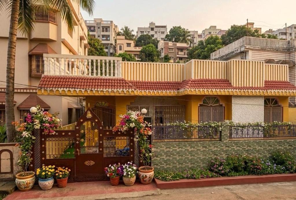 a house with potted plants in front of it at R S Homestay in Deoghar