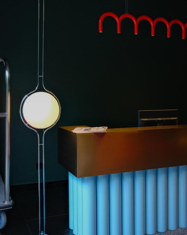 a room with a radiator and a table with a lamp at Proza Hotel & Restaurant in Kutaisi