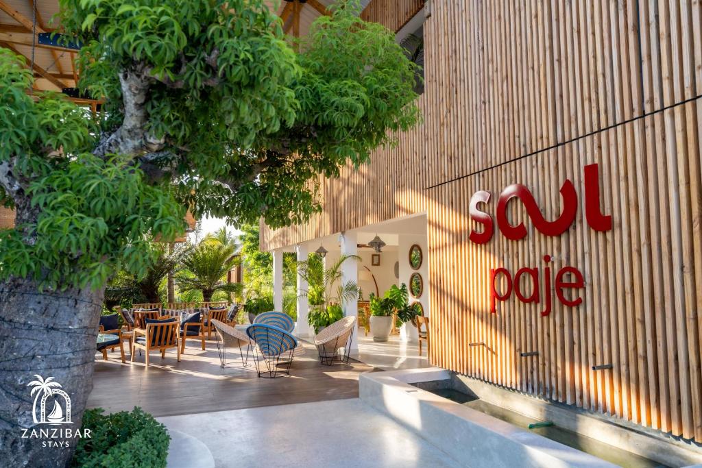 a restaurant with a sign on the side of a building at Zanzibar Stays Accommodation Collection, The Soul, Paje in Paje