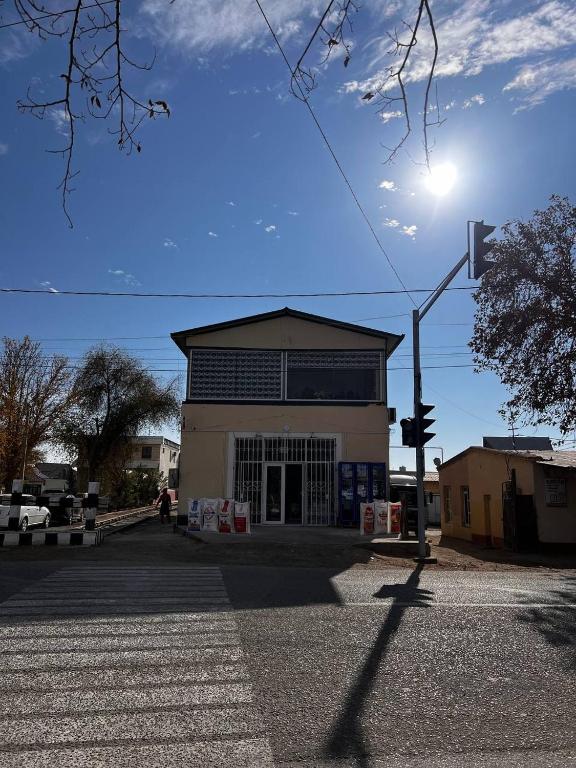 a building with a street light in front of it at Mezbon in Termiz