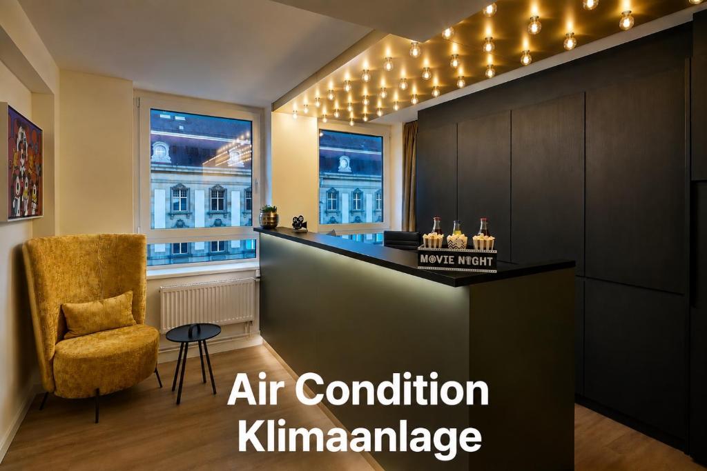 an office with an air condition killaminurance sign in a room with a chair at Cinema City Hotel Europaplatz Karlsruhe - Brand New Boutique Hotel 2025 - in Karlsruhe