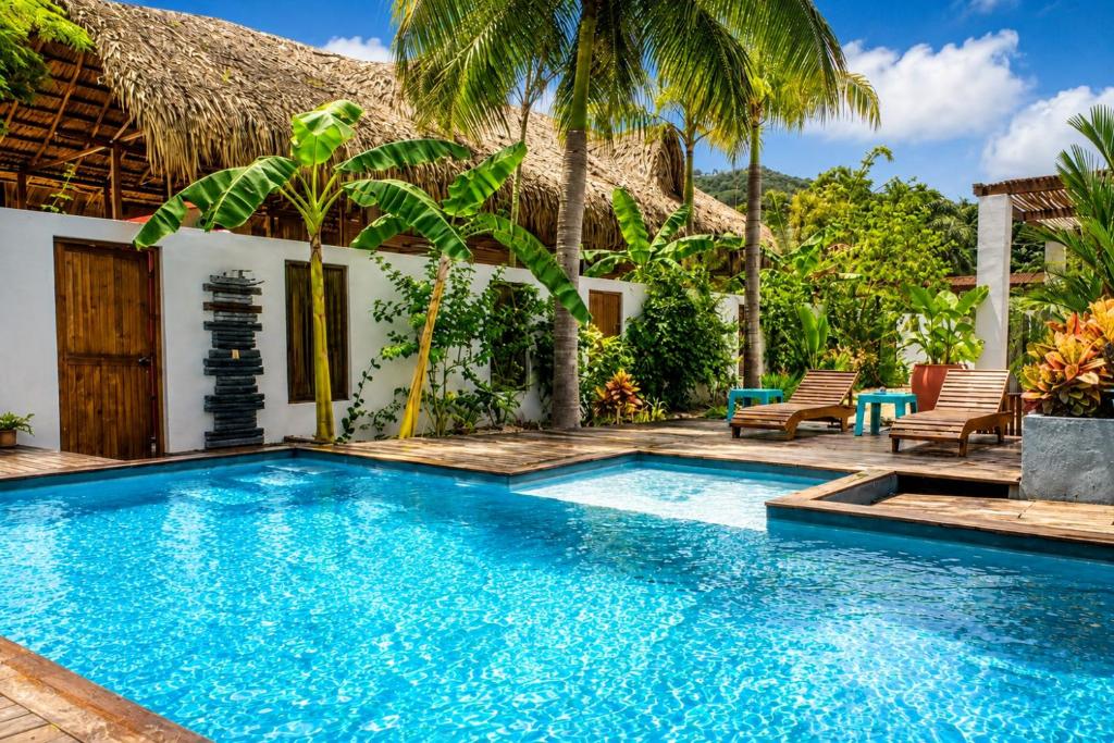 a swimming pool in front of a villa at Casa La Rayanna in Palomino