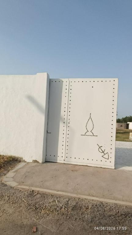 a white door on the side of a building at Chalet Dar Well-Ness in Dar Mohammed Salah