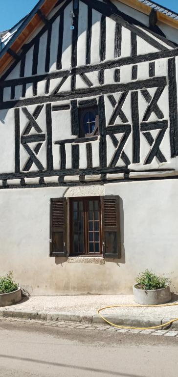 a building with a window on the side of it at Chambres d'Hôtes de La Vallée Du Serein in Annay-sur-Serein