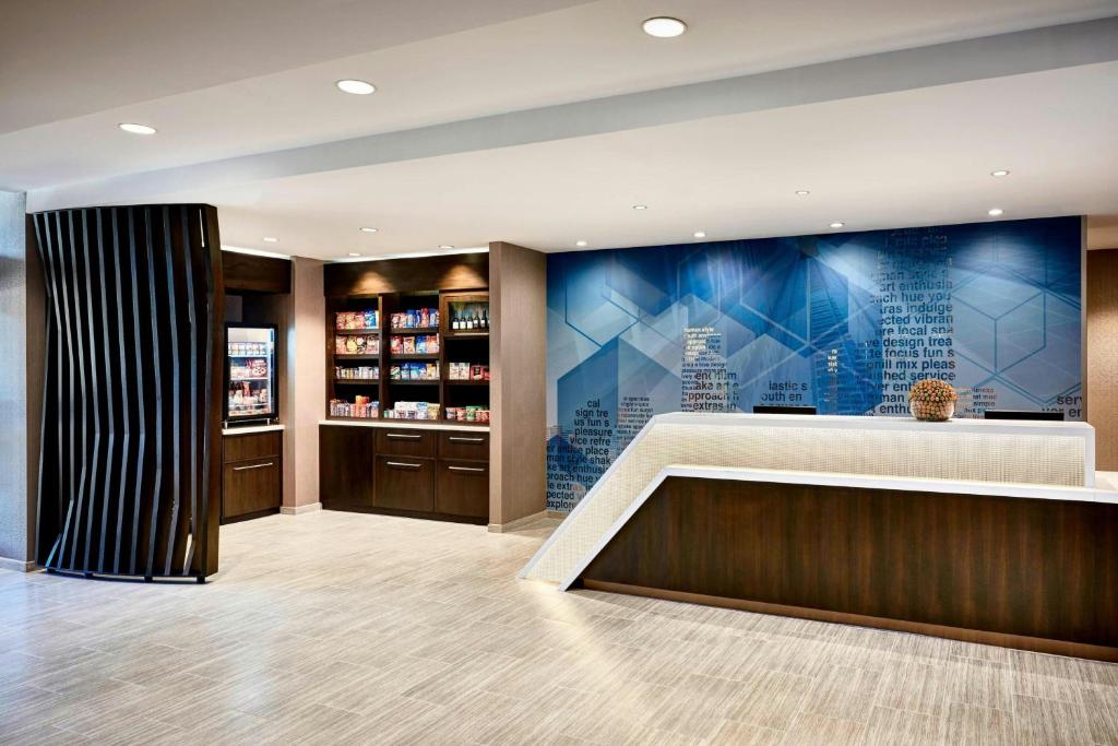 a hotel lobby with a reception desk and a pharmacy at SpringHill Suites by Marriott Appleton in Appleton