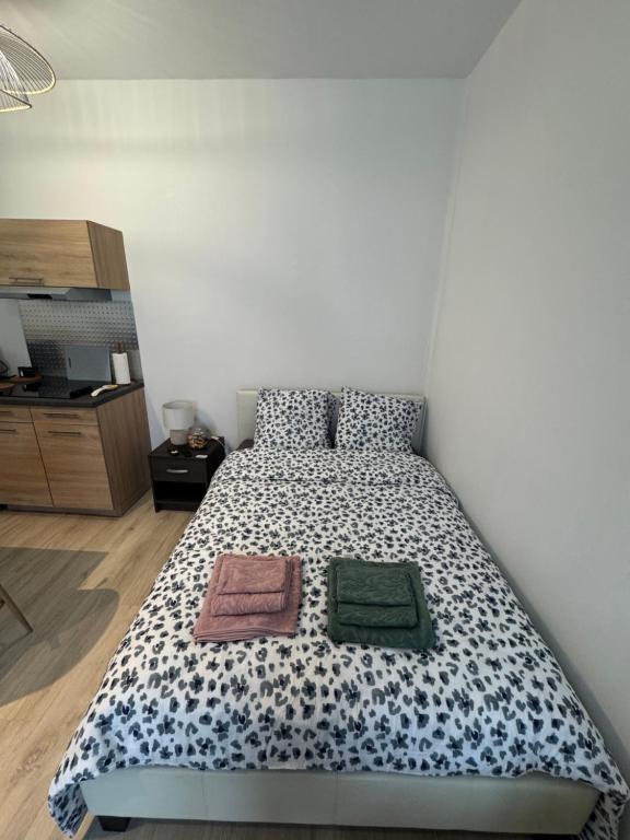 a bedroom with a bed with two towels on it at Le Nid Malouin in Saint Malo