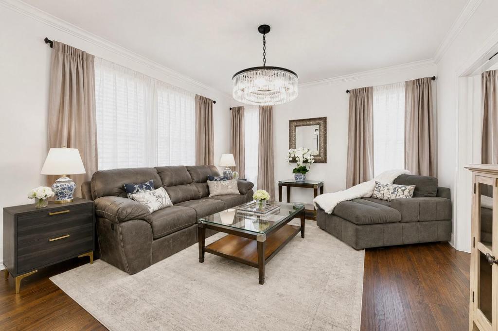 a living room with a couch and a table at Chic Dallas Retreat Trail, Soaking Tub & Patio in Dallas
