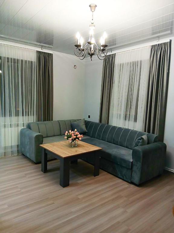 a living room with a couch and a coffee table at Elite Guest House in Goris