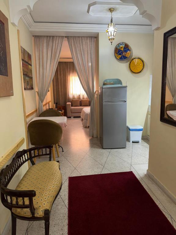 a living room with a chair and a couch at Appartement Wassim - Gueliz in Marrakesh