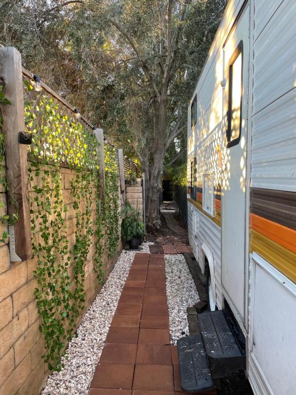 a bus is parked next to a fence at Cozy & Private Tiny House Style in Hickson