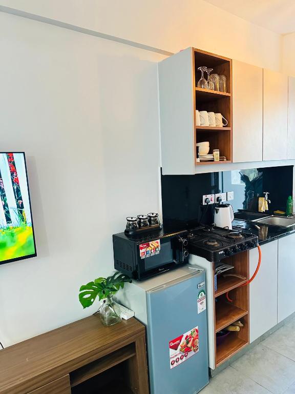 a small kitchen with a stove and a refrigerator at Suite Life in Kiambu